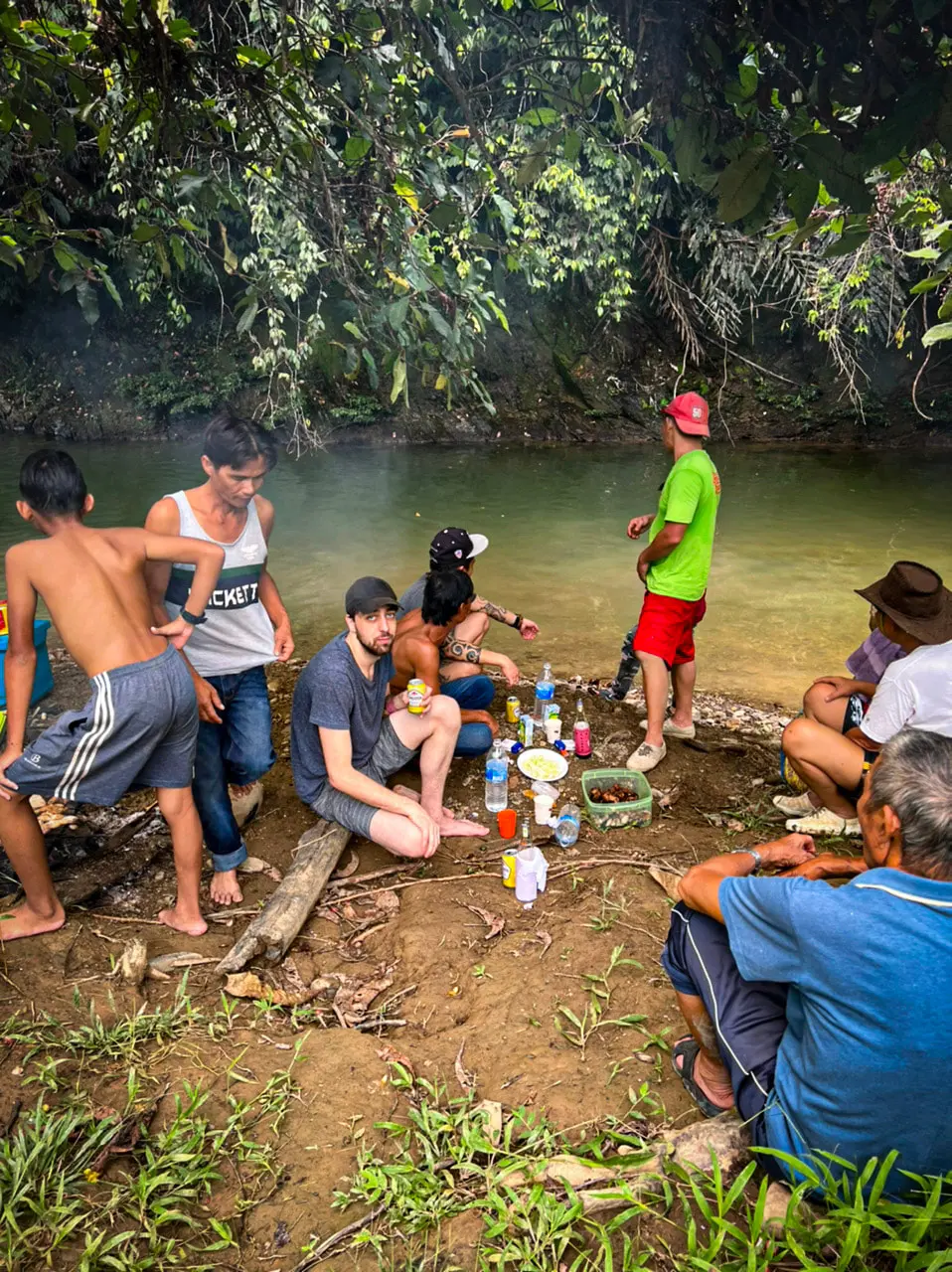 group of people having lunch by a river